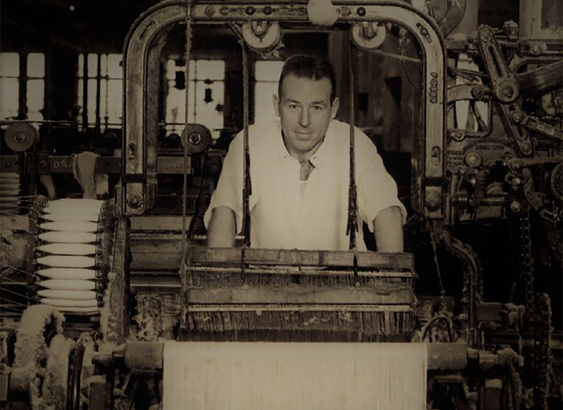 About Our Agency - Black and White Portrait of Springs Insurance Founder Colonel Springs Working in a Factory